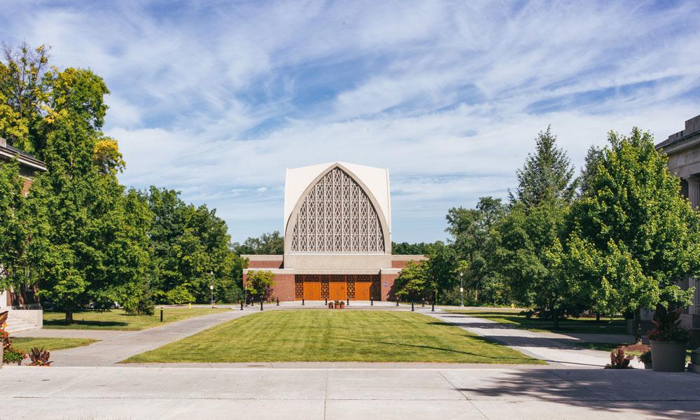 在这张照片中, exterior view of the Interfaith Chapel as seen from the George Eastman Quad on the University of Rochester's River Campus.